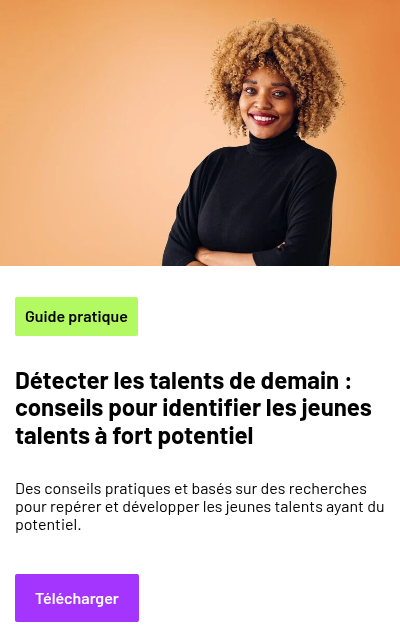 A person with curly hair wearing a plain turtleneck