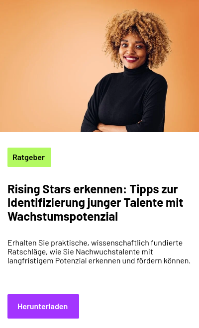 A person with curly hair wearing a plain turtleneck